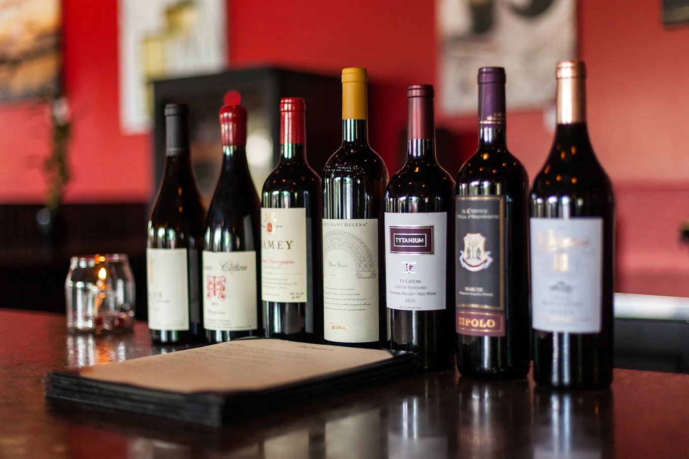 Selection of wine bottles displayed on a dark counter